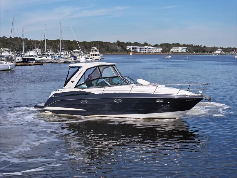 Slide: The Image of 2013 Monterey 340 Sport Yacht cruising on a calm marina. - 11