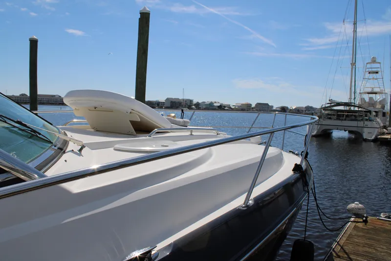 Slide: The Image of 2013 Monterey 340 Sport Yacht docked at a marina under a clear blue sky. - 18