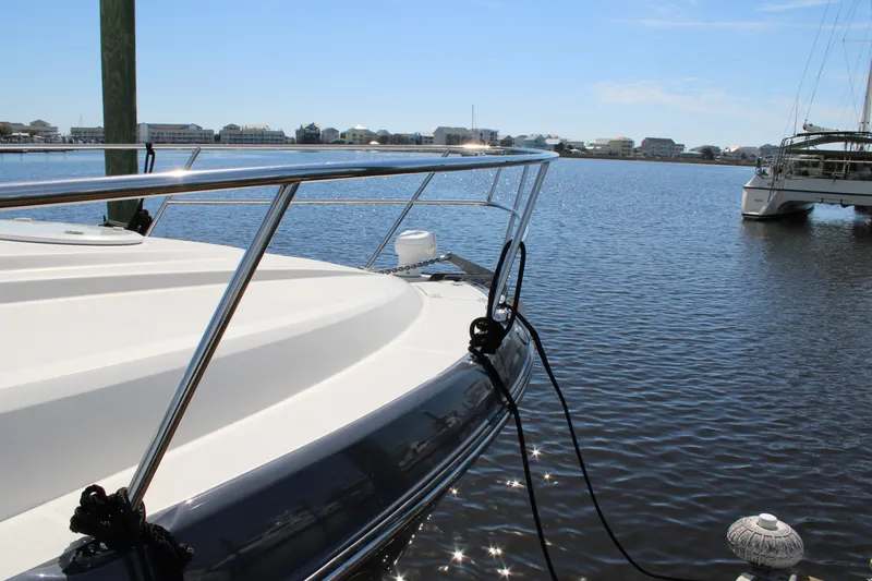 Slide: The Image of 2013 Monterey 340 Sport Yacht docked on calm water under clear blue sky. - 19