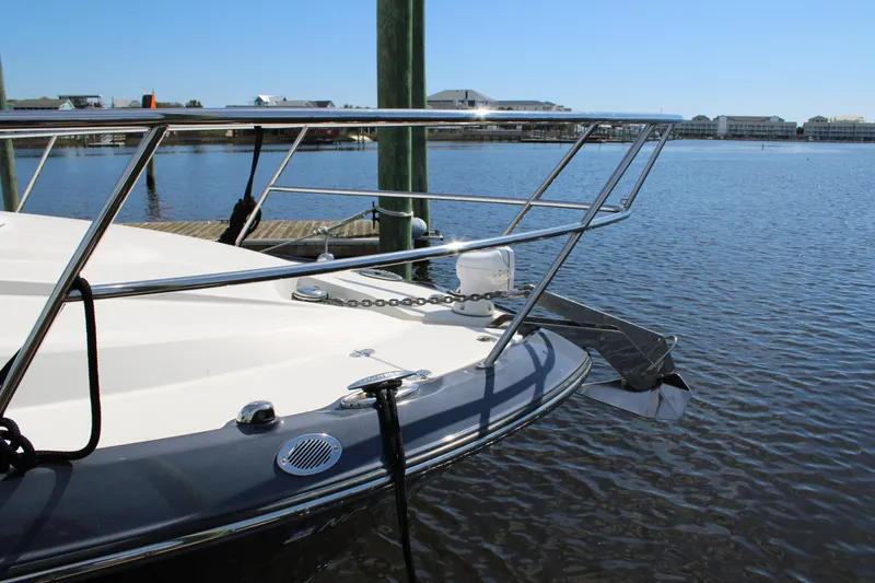 Slide: The Image of 2013 Monterey 340 Sport Yacht docked on calm water, showcasing sleek bow design. - 22