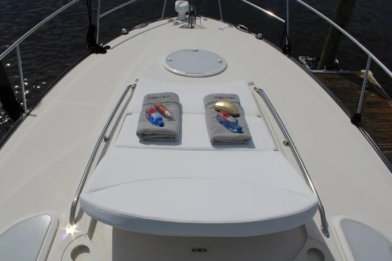 Slide: The Image of 2013 Monterey 340 Sport Yacht deck with towels and sunbathing area. - 23