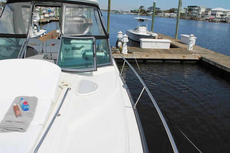 Slide: The Image of 2013 Monterey 340 Sport Yacht docked at marina with towel and drinks on deck. - 28