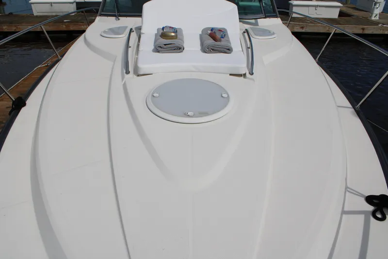 Slide: The Image of 2013 Monterey 340 Sport Yacht deck with sunbathing area and towels. - 30