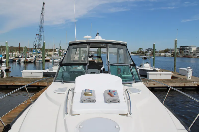 Slide: The Image of 2013 Monterey 340 Sport Yacht docked with towels on deck, marina background. - 33