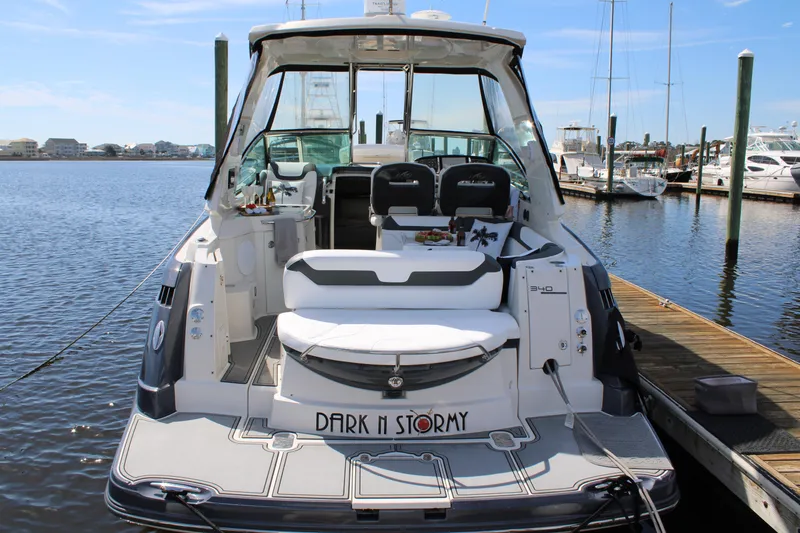 Slide: The Image of 2013 Monterey 340 Sport Yacht docked at marina, rear view with seating and clear skies. - 35