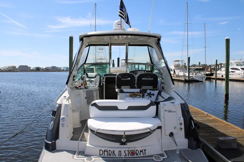 Slide: The Image of 2013 Monterey 340 Sport Yacht docked, rear view with seating and open cabin. - 36