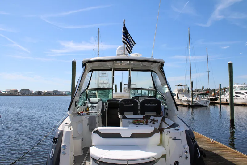 Slide: The Image of 2013 Monterey 340 Sport Yacht docked at marina under clear blue sky. - 37
