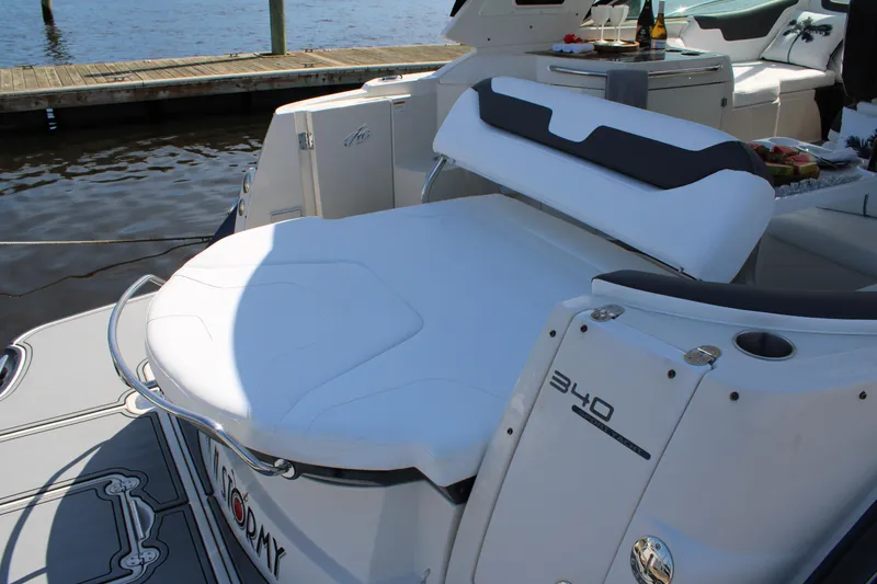 Slide: The Image of 2013 Monterey 340 Sport Yacht with spacious deck and seating at a dock. - 42