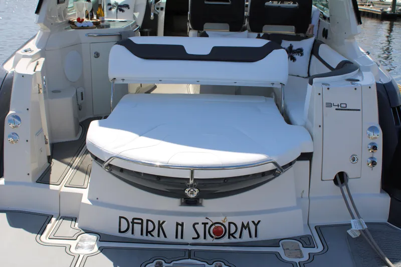 Slide: The Image of 2013 Monterey 340 Sport Yacht, rear view, "Dark n Stormy" nameplate, docked. - 43