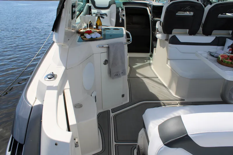 Slide: The Image of 2013 Monterey 340 Sport Yacht interior with seating and refreshments on a sunny day. - 45