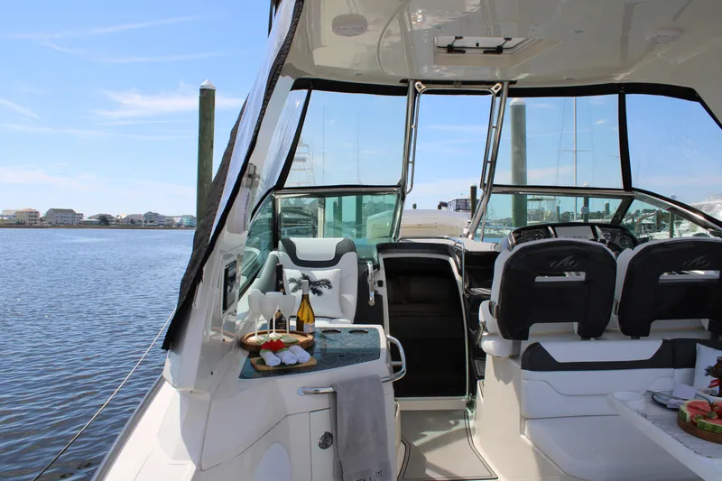 Slide: The Image of 2013 Monterey 340 Sport Yacht interior with seating, table, and water view. - 46
