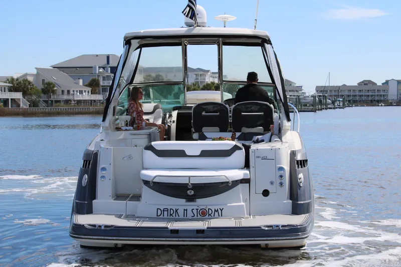Slide: The Image of 2013 Monterey 340 Sport Yacht cruising on a calm waterway, rear view. - 5