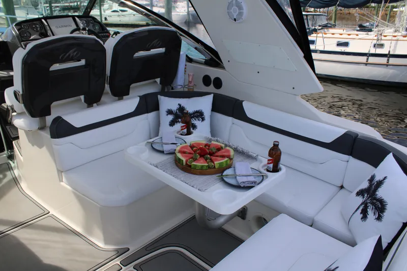 Slide: The Image of 2013 Monterey 340 Sport Yacht interior with seating, table, and refreshments. - 51