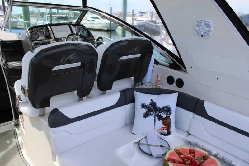 Slide: The Image of 2013 Monterey 340 Sport Yacht interior with seating, helm, and refreshments. - 52