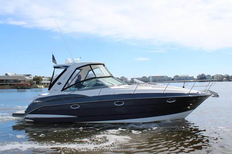 Slide: The Image of 2013 Monterey 340 Sport Yacht cruising on calm waters under a clear sky. - 8