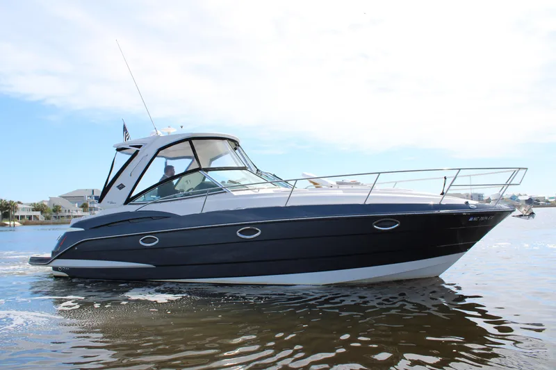 Slide: The Image of 2013 Monterey 340 Sport Yacht cruising on calm waters under a clear sky. - 9