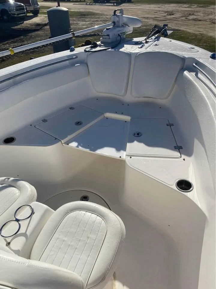 Slide: The Image of 2014 Sea Fox 256 Commander boat interior with white seating and storage compartments. - 5
