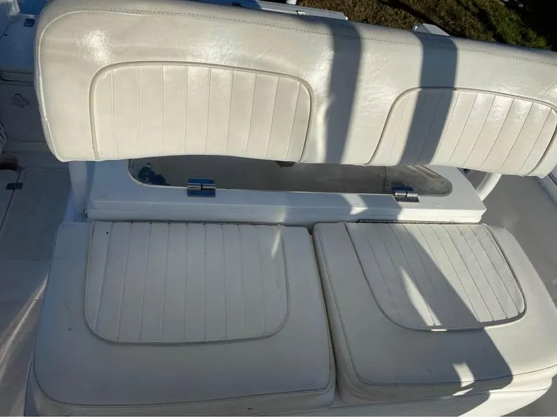 Slide: The Image of White seating on a 2014 Sea Fox 256 Commander boat, featuring cushioned upholstery. - 7