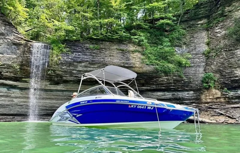 Slide: The Image of 2011 Yamaha AR240 High Output boat near a waterfall and rocky cliff. - 13