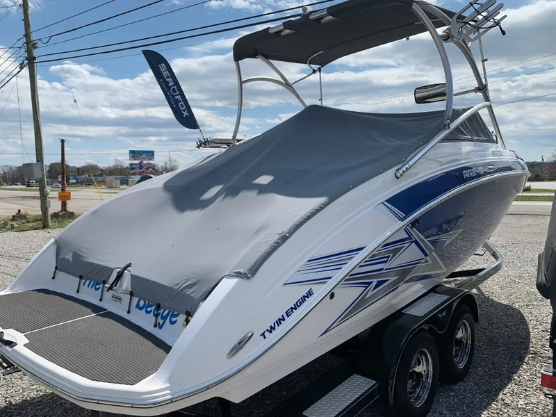 Slide: The Image of 2011 Yamaha AR240 High Output boat with cover on trailer, parked outdoors. - 16