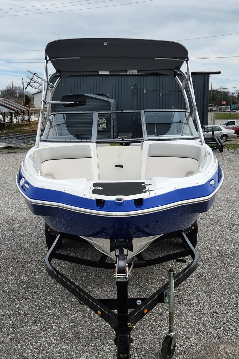 Slide: The Image of 2011 Yamaha Boats AR240 High Output, blue and white, on trailer, front view. - 3