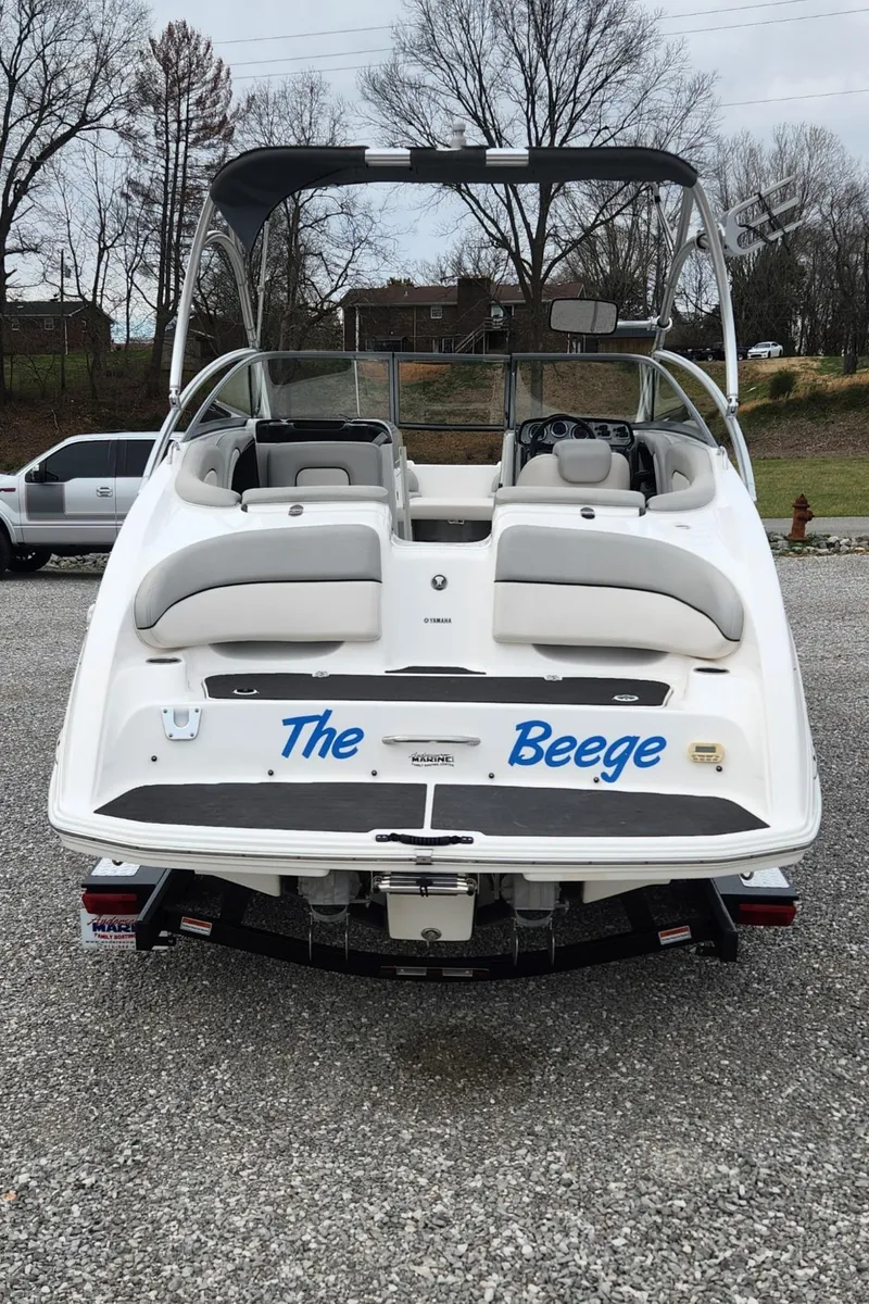 Slide: The Image of 2011 Yamaha Boats AR240 High Output, white, parked on gravel, rear view. - 4