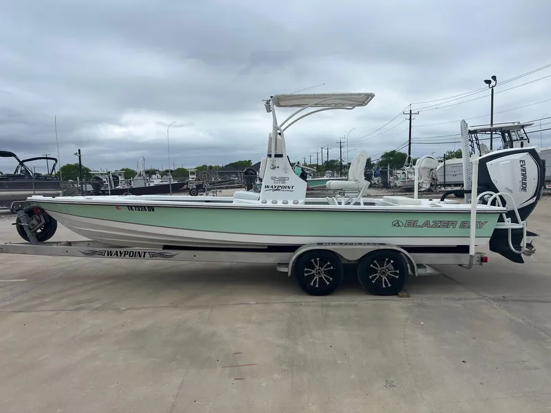 Slide: The Image of 2018 Blazer 2420 GTS boat on trailer, parked outdoors under cloudy sky. - 1