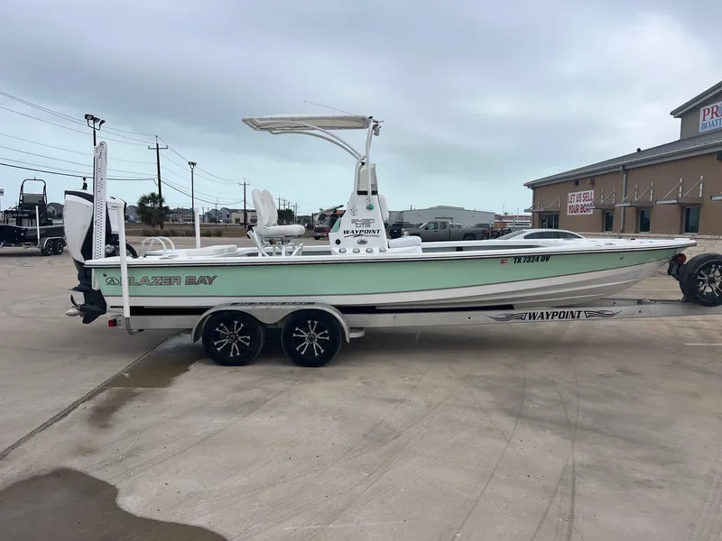 Slide: The Image of 2018 Blazer 2420 GTS boat on trailer, parked outdoors near a building. - 10