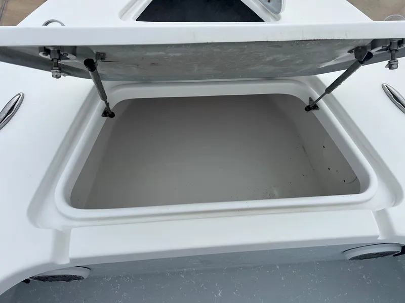 Slide: The Image of Open storage compartment on a 2018 Blazer 2420 GTS boat. - 17