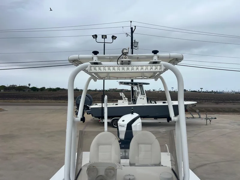 Slide: The Image of 2018 Blazer 2420 GTS boat with T-top and seating, parked outdoors. - 22