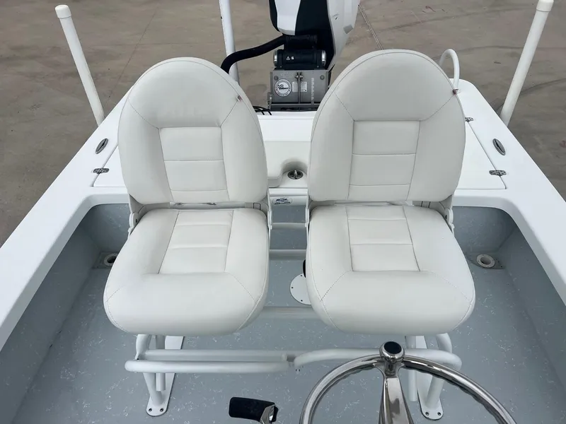 Slide: The Image of 2018 Blazer 2420 GTS boat with dual white seats and steering wheel. - 24