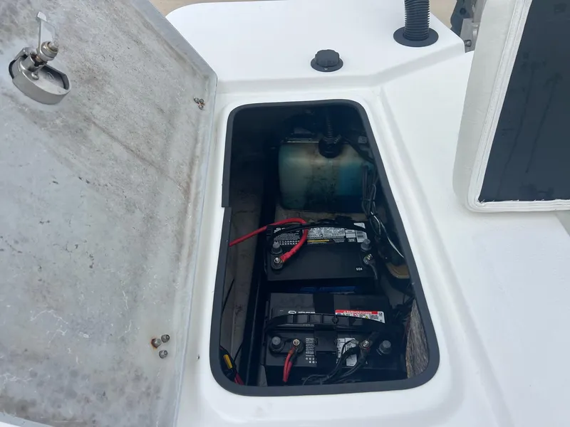 Slide: The Image of Open battery compartment of 2018 Blazer 2420 GTS boat, showing batteries and wiring. - 28