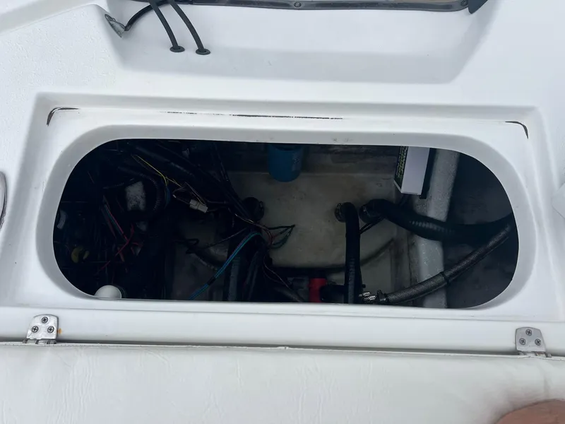 Slide: The Image of Open compartment of a 2018 Blazer 2420 GTS boat showing internal wiring and components. - 29