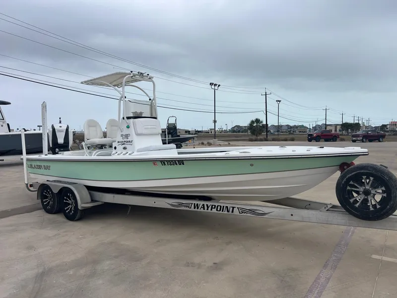 Slide: The Image of 2018 Blazer 2420 GTS boat on trailer in parking lot, overcast sky. - 9
