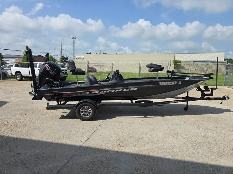 Slide: The Image of 2024 Bass Tracker PRO TEAM 190 boat, rear view, parked outdoors on concrete. - 4