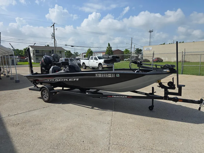 Slide: The Image of 2024 Bass Tracker PRO TEAM 190 boat on trailer in outdoor setting. - 5