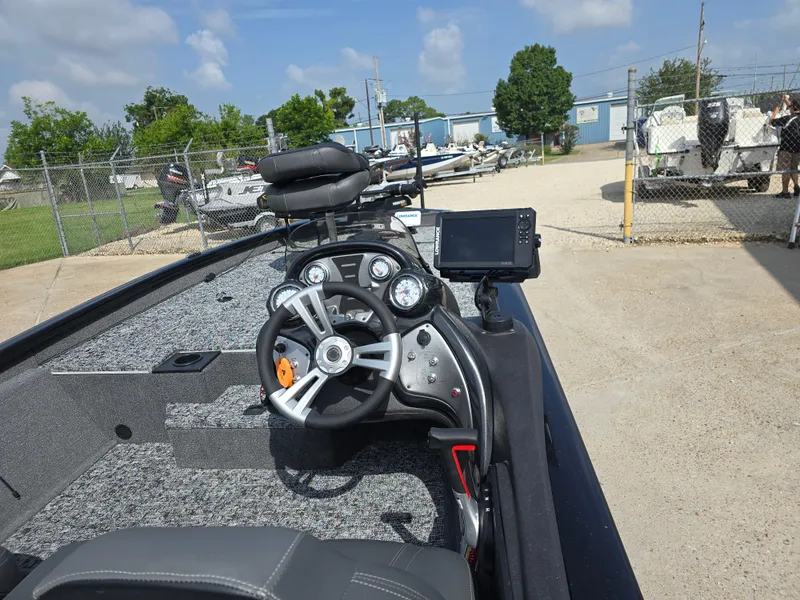 Slide: The Image of 2024 Bass Tracker PRO TEAM 190 boat dashboard with steering wheel and navigation system. - 7