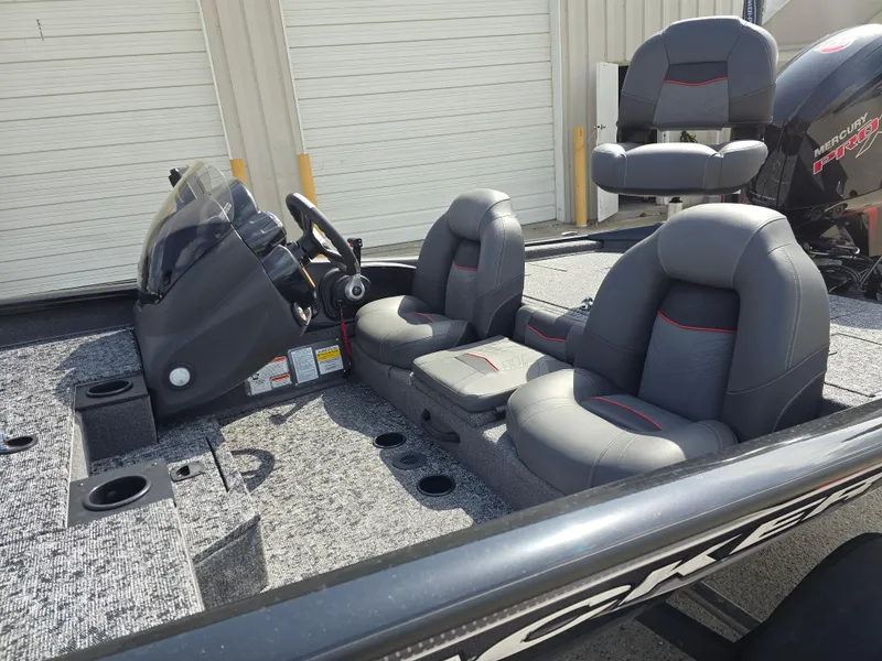 Slide: The Image of 2024 Bass Tracker PRO TEAM 190 boat interior with gray seating and steering console. - 9