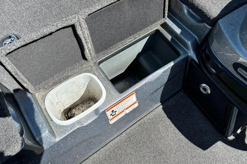 Slide: The Image of 2014 Nitro Z-8 boat storage compartments with carpeted interior and utility bins. - 6