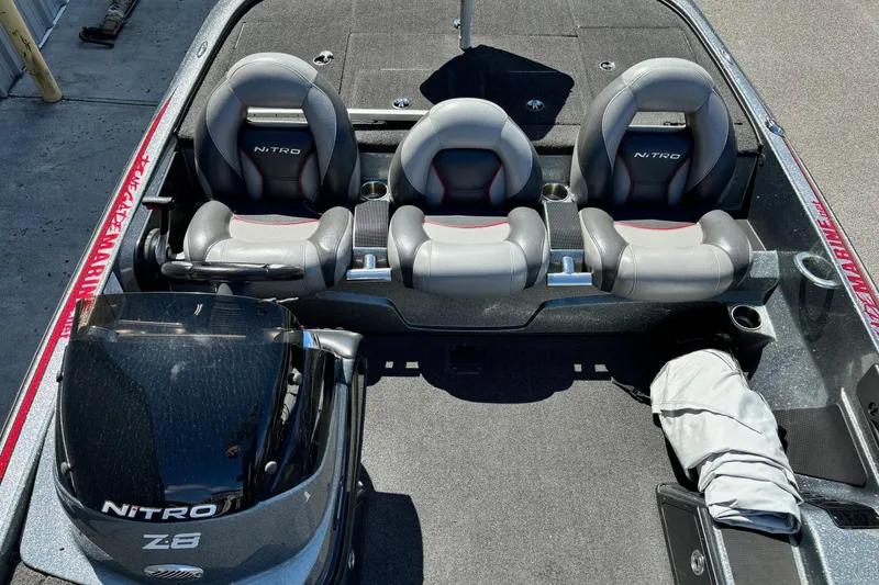 Slide: The Image of 2014 Nitro Z-8 boat interior with three seats and engine, showcasing sleek design. - 8