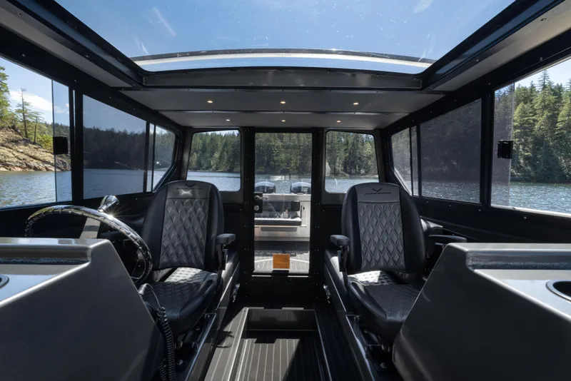 Slide: The Image of Interior of 2025 Jasper Marine Defender 22 boat with panoramic windows and luxury seating. - 14