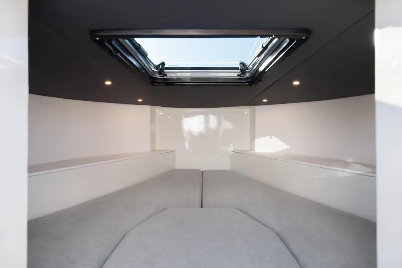 Slide: The Image of Interior cabin of 2025 Jasper Marine Defender 22 - Storm Bow, featuring sleek design and skylight. - 4