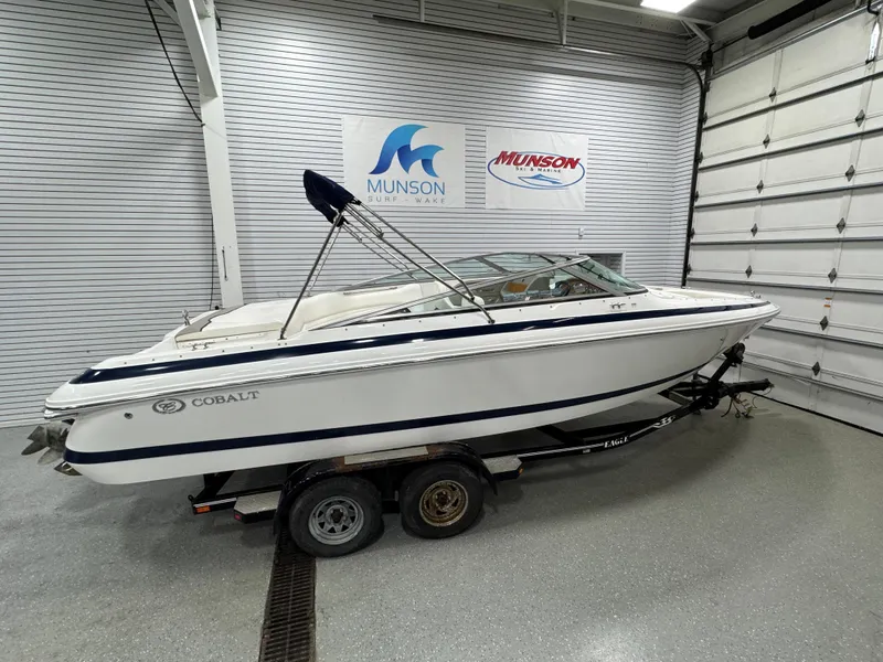 Slide: The Image of 2001 Cobalt 246 boat on trailer in showroom with Munson signage. - 1
