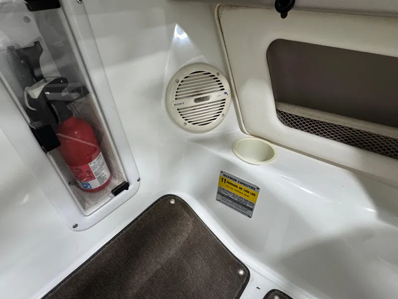 Slide: The Image of Interior of a 2001 Cobalt 246 boat with fire extinguisher and speaker. - 14