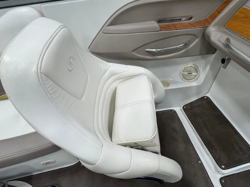 Slide: The Image of Interior of a 2001 Cobalt 246 boat with white leather seating and wood accents. - 15