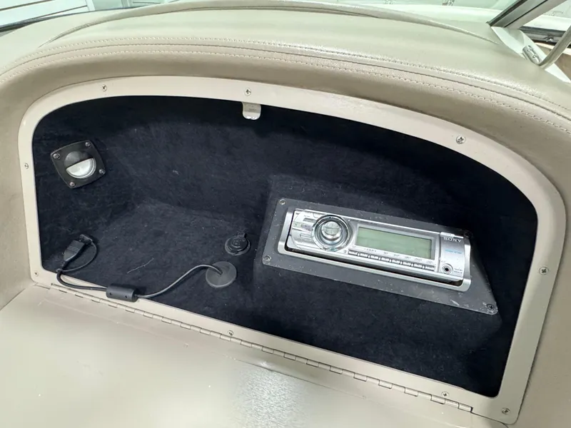 Slide: The Image of 2001 Cobalt 246 boat dashboard with stereo system and speaker. - 16
