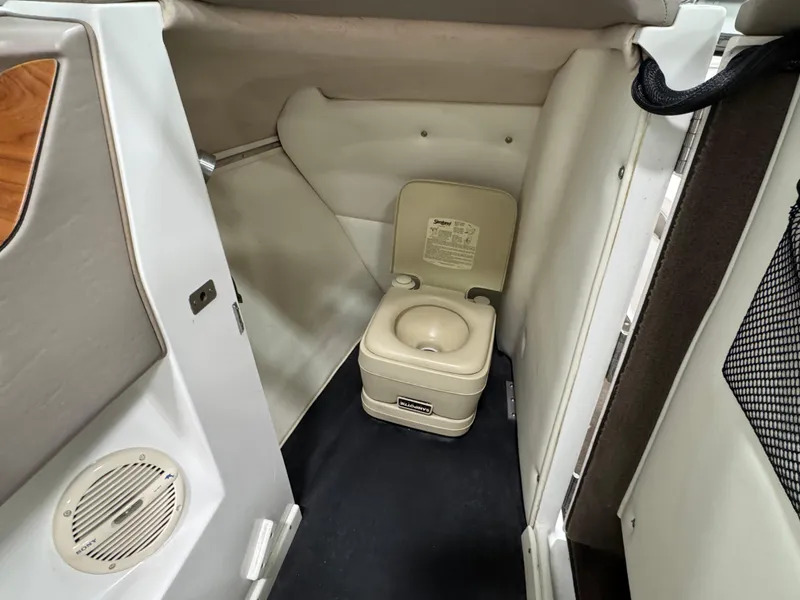 Slide: The Image of Compact marine toilet inside a 2001 Cobalt 246 boat cabin. - 17