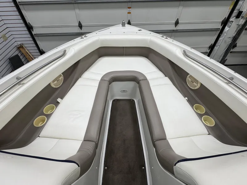 Slide: The Image of 2001 Cobalt 246 boat interior with white and gray seating, cup holders, and speakers. - 18