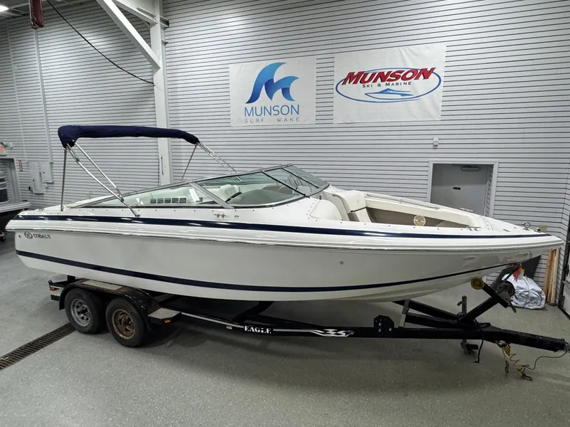 Slide: The Image of 2001 Cobalt 246 boat on trailer in showroom with Munson Marine signage. - 2