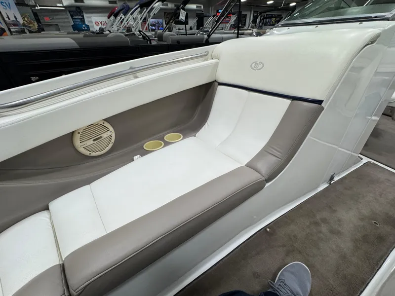 Slide: The Image of Interior seating of a 2001 Cobalt 246 boat, featuring beige and white upholstery. - 20